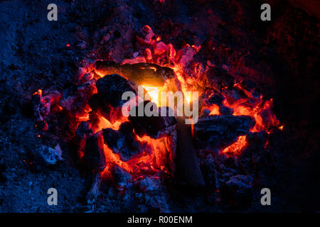A small camp fire provides plenty of heat on a chilly evening in the mountains. Stock Photo