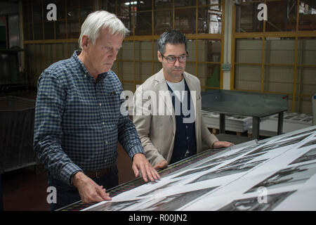 Dewi Lewis British photography book publisher on press publishing My British Archive, The Way We Were 1968-1983 at EBS Verona Italy. Jonathan Bortolazzi MD of EBS looking at page proofs. 2018 HOMER SYKES Stock Photo
