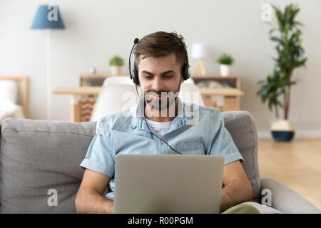 Man using headset and laptop working studying at home Stock Photo