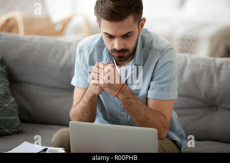 Man studying using computer reading message online Stock Photo