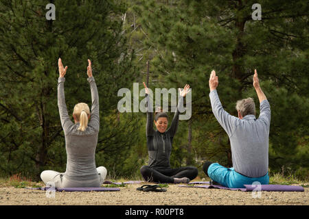Instructor Sandi Hagle leads a morning yoga class on the Middle Fork Salmon River in Idaho with outfitter Far And Away Adventures. Stock Photo