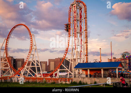 oney Island boardwalk in Brooklyn with amusement park rides Stock Photo