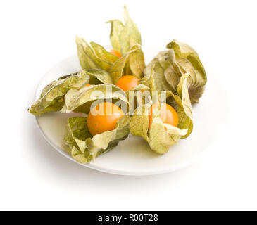 Physalis peruviana fruit on plate isolated on white background. Stock Photo