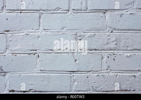 Fragment of old brick walls covered with many layers of paint and lime Stock Photo