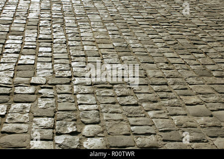 Part of urban square covered with cobblestone. Sunlight reflected on the stones Stock Photo