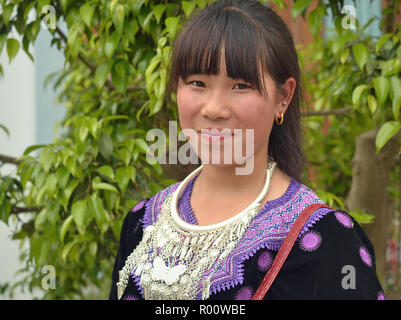 Vietnamese H’mong teenage girl wears her clan’s traditional Sunday Best during the weekly market day. Stock Photo