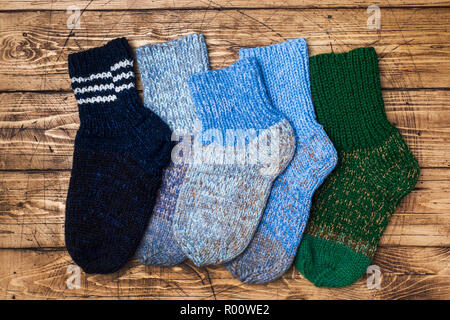 Warm wool knitted socks for cold winter on wooden background Stock Photo