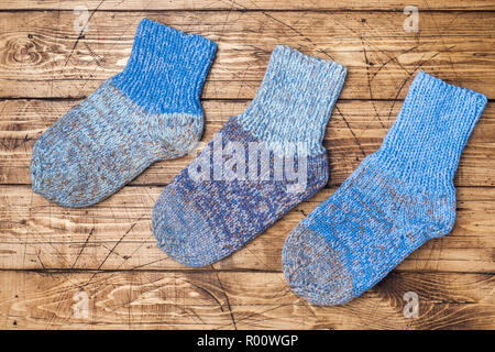 Warm wool knitted socks for cold winter on wooden background Stock Photo