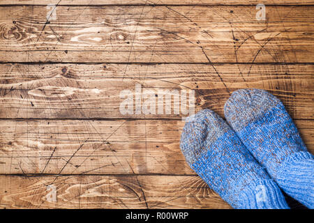 Legs in woolly knitted socks on wooden background Copy space Stock Photo