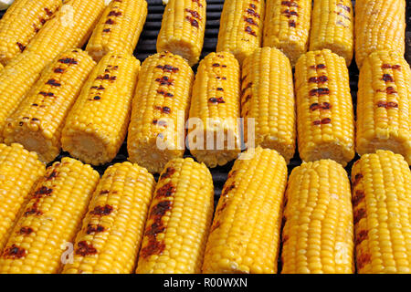 Corn. Fresh organic corn cobs grilling on a barbeque. Grilled corns. Yellow baked corn cobs. Grilled corn background texture. Roasted vegetables wallp Stock Photo