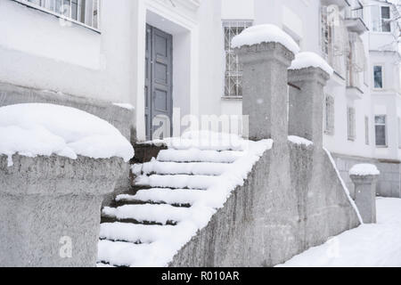 Side view of facade of  house with snow-covered staircase. Stock Photo