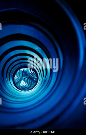 Abstract blue spirals and tubulars optical effect through galvanised construction pipes Stock Photo