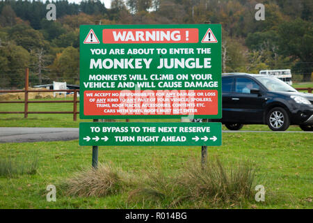 Complete with warning signs for car drivers and vehicle owners, the entrance to the monkey jungle reserve, part of Longleat Safari Park Trail. UK (103) Stock Photo