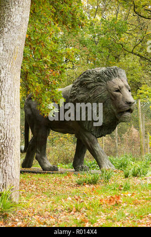 Lion statue / sculpture for visitors, car passengers & drivers to see following the Safari Park trail route at Longleat Safari Park, Wiltshire, UK Stock Photo