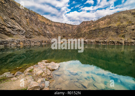 Gorgeous golden trees and rocks are reflected in the lake, beautiful landscape, autumn outdoor Stock Photo