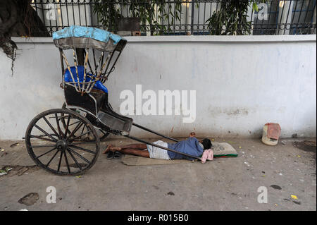 Kolkata, India, Asia, A rikshawker sleeping at the roadside Stock Photo