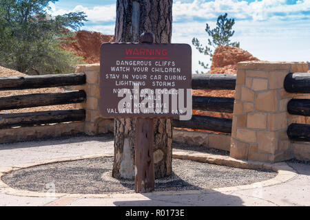 Warning sign posted at Bryce Canyon National Park informs tourists of dangerous conditions on the trails Stock Photo