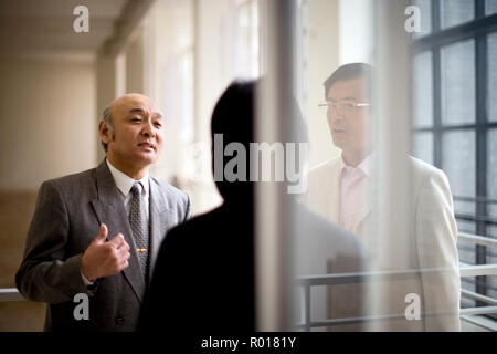 Mature businessman talking with colleagues in a building. Stock Photo
