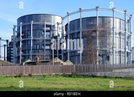 A cluster of three historic gas-holders re-erected in redeveloped rail-lands near King’s Cross modern apartments, built inside their frames Stock Photo