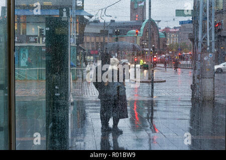 Couple in the rain on Mannerheimintie street in Helsinki FInland Stock Photo