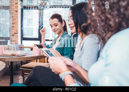 Joyful nice women chatting in social media Stock Photo