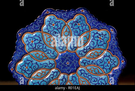 Iranian dish with arabesques on black background Stock Photo