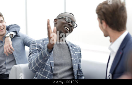 close up.cheerful co-workers giving each other a high five Stock Photo