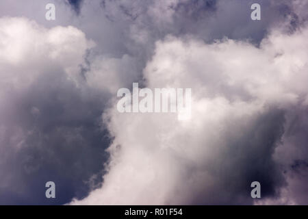storm cloud on sunny day. light in the dark and dramatic storm clouds. background of storm clouds before a thunderstorm Stock Photo