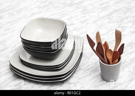 Ceramic plates and wooden utensils on marble background. Stock Photo
