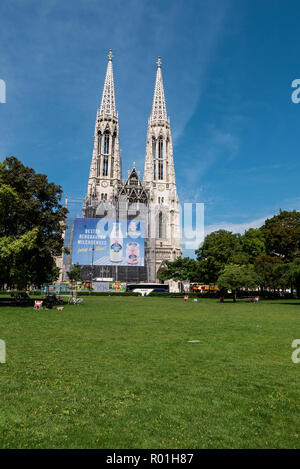 Votivkirche in Vienna turned billboard, an eyesore that lessens the city's readability and reveals dysfunctional local authorities. How dare they? Stock Photo