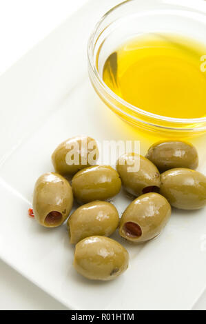 Healthy Olive Oil in a Glass Bowl with Green Olives Isolated on white Stock Photo