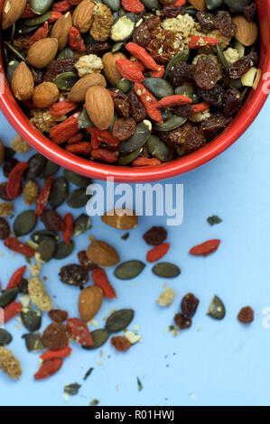 Different delicious nuts on light blue background, flat lay. Space for ...