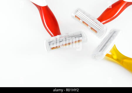 Red and Yellow Disposable Razors Isolated on White Background Stock Photo