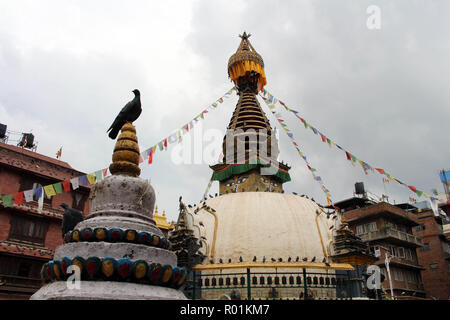 The birds around the stupa (and its eyes) in the middle of Kathmandu local market. Taken in Nepal, August 2018. Stock Photo