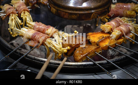 Assorted meat from chicken and pork and various vegetables on barbecue grill . Stock Photo