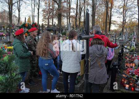 ZACHELMIE, POLAND - OCTOBER 31, 2018: A group of school children stand in front of a grave of Polish soldiers and listen to a guide telling them how they died during the World War II. Credit: Slawomir Wojcik/Alamy Live News Stock Photo