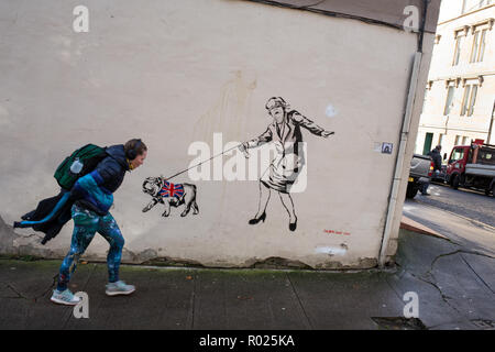 Glasgow, Scotland, 1st November 2018. A blindfolded Prime Minister Theresa May leading a British bulldog wearing a Union jack coat - a Brexit commentary street art stencilled graffiti /mural by the artist known as 'The Pink Bear Rebel', in the West End of Glasgow, Scotland, on 01 November 2018. Image Credit: Jeremy Sutton-Hibbert/Alamy News Credit: jeremy sutton-hibbert/Alamy Live News Stock Photo