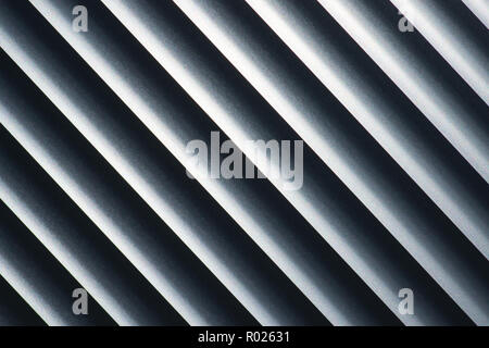 An abstract look at metal blinds with a diagonal tilt, with emphasis on highlights and shadows. Stock Photo