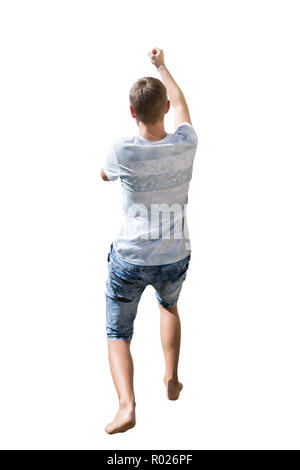 Rear view full length portrait of active young man pulling something imaginary or hanging hold with hand isolated over white background. Stock Photo