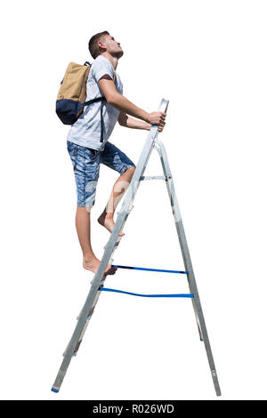 Side view full length portrait of a casual young man traveler climbing a ladder carrying a backpack looking up isolated over white background. Stock Photo