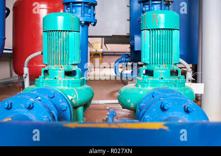 Blue engine with a pump connected to the pipes blue. Stock Photo