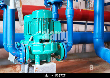 Blue engine with a pump connected to the pipes blue. Stock Photo