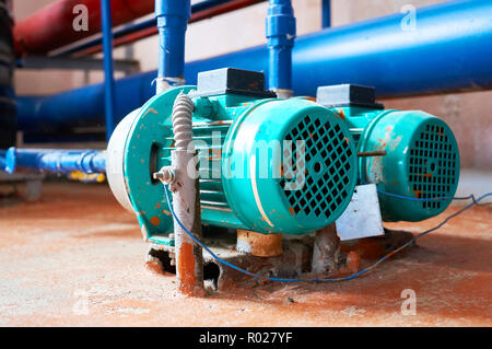 Blue engine with a pump connected to the pipes blue. Stock Photo