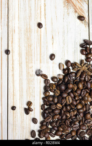 Coffee beans with anise on white wooden background. Stock Photo