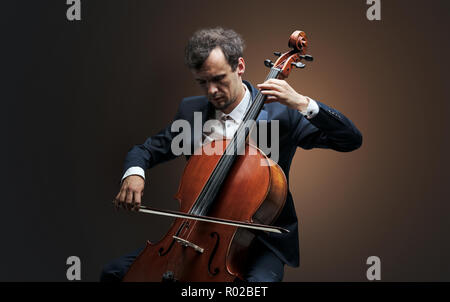Lonely cellist composing on cello with nothing around Stock Photo - Alamy