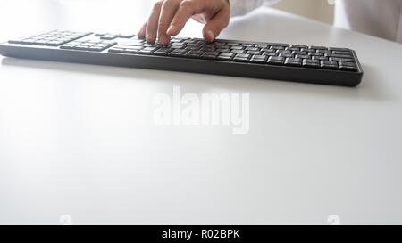 Male hand using black computer keypad. With copy space. Stock Photo