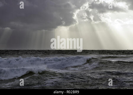 Stormy sea sky with sunbeam between clouds Stock Photo