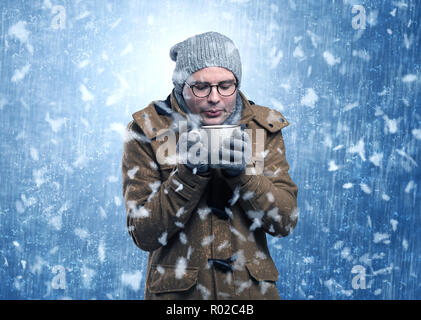 Handsome young boy shivering and trembling at snowstorm concept  Stock Photo