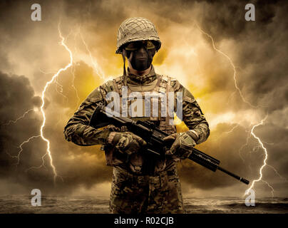 Armed soldier standing in rainy obscure weather  Stock Photo