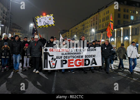 Supporters of Pegida are seen holding a banner during the protest. The Pegida (Patriotic Europeans against the Islamization of the West) weekly protest at the Neumarkt Square. Stock Photo
